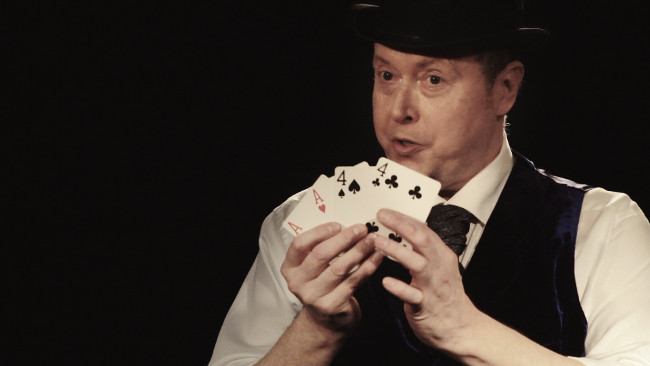 Peter as Charles Dickens showing four cards