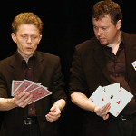 Peter Rosengren and Tom Stone comparing cards trying to outdo one another