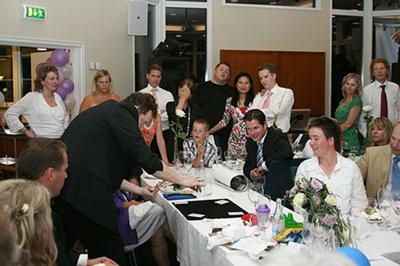 Peter performing at the head table during a wedding